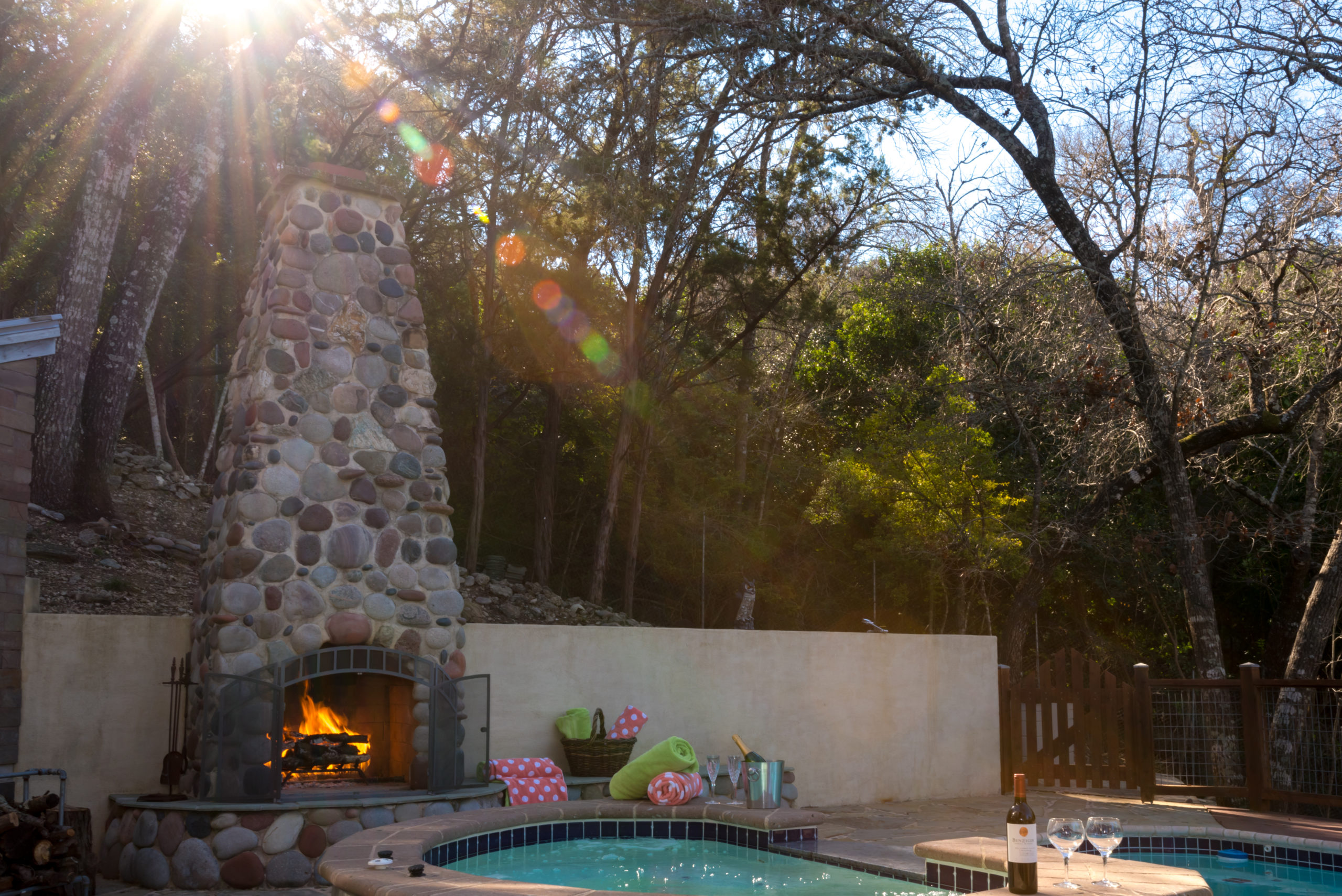 Pool area with hot tub and fireplace
