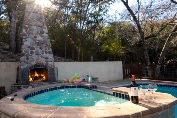 Hot tub and fireplace, with wine and wine glasses